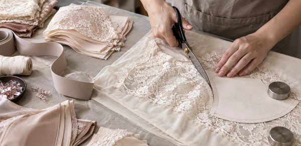 Lace cutting and materials detail at Qijin factory